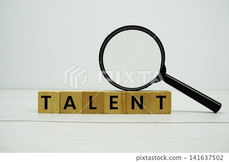 TALENT alphabet letters with magnifying glass on wooden background TALENT alphabet letters with magnifying glass on wooden background 141637502