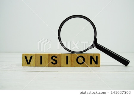 VISION alphabet letters with magnifying glass on wooden background VISION alphabet letters with magnifying glass on wooden background 141637503