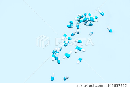 Floating blue and white pharmaceutical capsules on clean background. Medicine, healthcare innovation, drug development, biotechnology and clinical pharmaceutical research. Pharmaceutical industry. Floating blue and white pharmaceutical capsules on clean background. Medicine, healthcare innovation, drug development, biotechnology and clinical pharmaceutical research. Pharmaceutical industry. 141637712