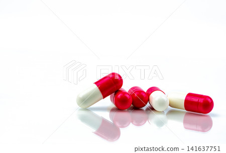 Minimal pink and white prescription capsule medication on white background, pharmaceutical healthcare concept for pharmacy, hospital treatment and medical industry. Drug industry. Medical Innovation. Minimal pink and white prescription capsule medication on white background, pharmaceutical healthcare concept for pharmacy, hospital treatment and medical industry. Drug industry. Medical Innovation. 141637751