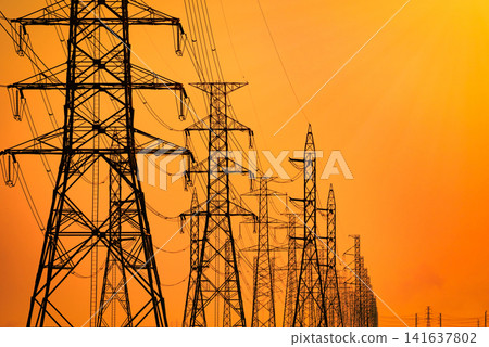 Power transmission lines and electricity pylon with sunset sky. Electrical infrastructure, energy security, sustainable development, engineering and modern utility network. Renewable energy transition Power transmission lines and electricity pylon with sunset sky. Electrical infrastructure, energy security, sustainable development, engineering and modern utility network. Renewable energy transition 141637802