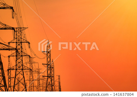 High voltage electricity transmission towers and power lines at sunset. Energy infrastructure, electrical grid, utility network, sustainable power supply and engineering. Renewable energy transition. High voltage electricity transmission towers and power lines at sunset. Energy infrastructure, electrical grid, utility network, sustainable power supply and engineering. Renewable energy transition. 141637804