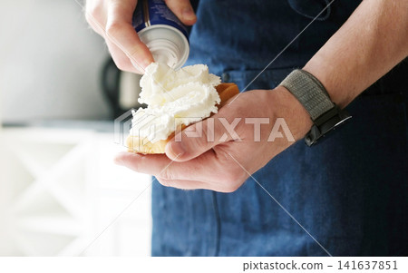 Chef Adding A Topping Whipped Cream On A Belgium Waffle, Close U Chef Adding A Topping Whipped Cream On A Belgium Waffle, Close U 141637851