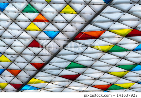 Polycarbonate roof with geometric triangle pattern on modern building canopy, translucent skylight architecture featuring polymer panels for contemporary exterior design and abstract background. Polycarbonate roof with geometric triangle pattern on modern building canopy, translucent skylight architecture featuring polymer panels for contemporary exterior design and abstract background. 141637922
