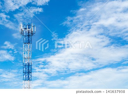 Telecommunication tower with blue sky and white clouds background. Antenna on blue sky. Radio and satellite pole. Communication technology. Telecommunication industry. Mobile or telecom 4g network. 141637938