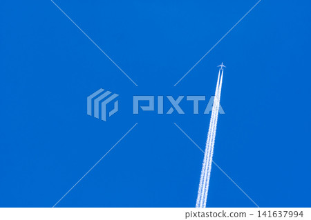 Airplane with white condensation tracks. Jet plane on blue sky and white clouds with vapor trail. Travel by airplane concept. Trails of exhaust gas from airplane engine. Aircraft with white stripes. Airplane with white condensation tracks. Jet plane on blue sky and white clouds with vapor trail. Travel by airplane concept. Trails of exhaust gas from airplane engine. Aircraft with white stripes. 141637994