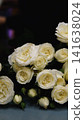 Beautiful white roses in a flower shop. Florist assembles a bouquet to order 141638024