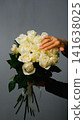 Beautiful white roses in a flower shop. Florist assembles a bouquet to order 141638025