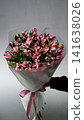 Female florist arranges delicate bouquet of pink alstroemeria flowers. Flower delivery. Small business concept 141638026