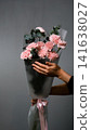 Bouquet of pink carnations on a gray background. Florist assembly a bouquet to order 141638027