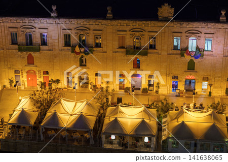 VALLETTA, MALTA - NOVEMBER 12, 2018 - Panoramic night view of a coast line and the downtown of the city with different landmarks VALLETTA, MALTA - NOVEMBER 12, 2018 - Panoramic night view of a coast line and the downtown of the city with different landmarks 141638065