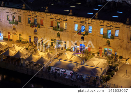 VALLETTA, MALTA - NOVEMBER 12, 2018 - Panoramic night view of a coast line and the downtown of the city with different landmarks VALLETTA, MALTA - NOVEMBER 12, 2018 - Panoramic night view of a coast line and the downtown of the city with different landmarks 141638067