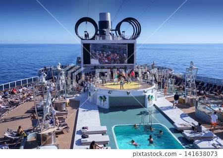 BARCELONA, SPAIN- 06 NOVEMBER, 2018: An aerial view of a cruise ship pool area with people in the open sea BARCELONA, SPAIN- 06 NOVEMBER, 2018: An aerial view of a cruise ship pool area with people in the open sea 141638073