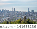 Coastal city skyline with modern highrises and old church on hillside. 141638136