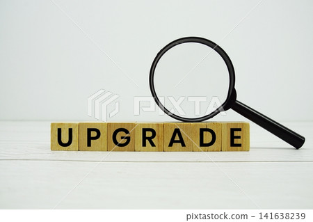 UPGRADE alphabet letters with magnifying glass on wooden background UPGRADE alphabet letters with magnifying glass on wooden background 141638239