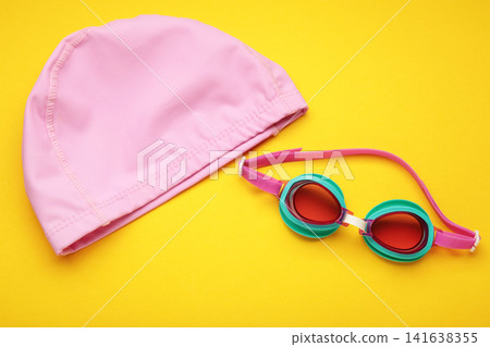 Swimming mask and goggles on yellow background. Swimming mask and goggles on yellow background. 141638355