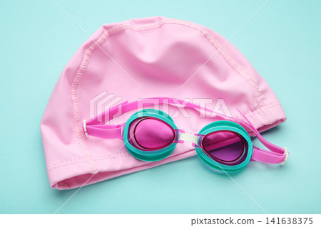 Swimming mask and goggles on light blue background. Swimming mask and goggles on light blue background. 141638375