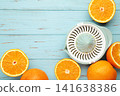 Squeezer and orange fruits on blue wooden background. Space for text 141638386