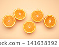 Half of fresh orange fruit on beige background. 141638392