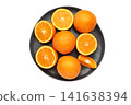Fresh orange fruit on dark plate isolated on white background. 141638394