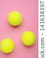 Bright yellow tennis balls on pink background. Vertical photo 141638397