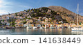 Panoramic View of Symi Harbor with Colorful Hillside Houses in Dodecanese Greece 141638449