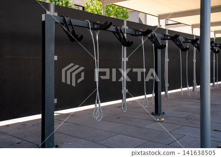Modern covered bike parking racks in Fuerstenfeldbruck, Bavaria, Germany, empty bicycle parking area in urban street on sunny day 141638505