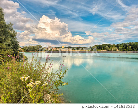 Vertical floating solar power plant on turquoise quarry lake in Gilching, Bavaria: Innovative floating photovoltaic panels on lake, renewable energy concept, sustainable electricity generation Vertical floating solar power plant on turquoise quarry lake in Gilching, Bavaria: Innovative floating photovoltaic panels on lake, renewable energy concept, sustainable electricity generation 141638538