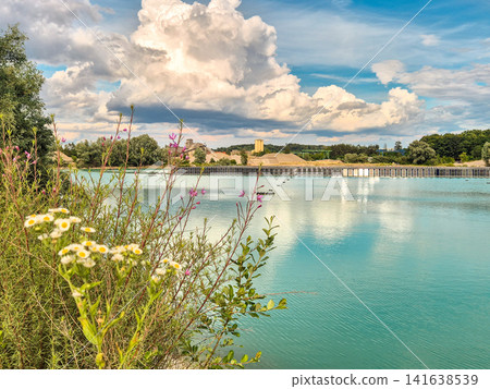 Vertical floating solar power plant on turquoise quarry lake in Gilching, Bavaria: Innovative floating photovoltaic panels on lake, renewable energy concept, sustainable electricity generation Vertical floating solar power plant on turquoise quarry lake in Gilching, Bavaria: Innovative floating photovoltaic panels on lake, renewable energy concept, sustainable electricity generation 141638539