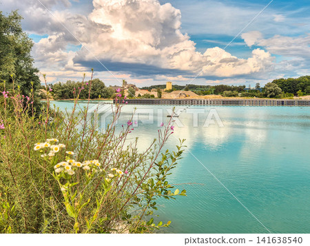 Vertical floating solar power plant on turquoise quarry lake in Gilching, Bavaria: Innovative floating photovoltaic panels on lake, renewable energy concept, sustainable electricity generation 141638540