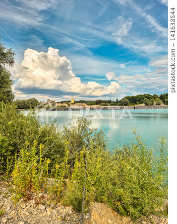 Vertical floating solar power plant on turquoise quarry lake in Gilching, Bavaria: Innovative floating photovoltaic panels on lake, renewable energy concept, sustainable electricity generation Vertical floating solar power plant on turquoise quarry lake in Gilching, Bavaria: Innovative floating photovoltaic panels on lake, renewable energy concept, sustainable electricity generation 141638544
