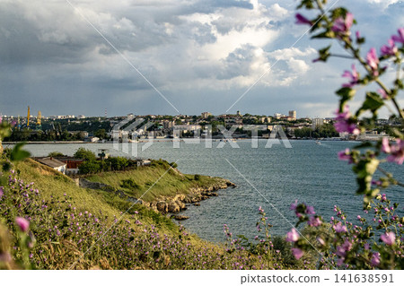 Sevastopol Bay in spring - Severnaya Storona waterfront with flowering coastline, Crimea, Ukraine Sevastopol Bay in spring - Severnaya Storona waterfront with flowering coastline, Crimea, Ukraine 141638591