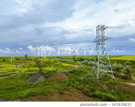 View from train window passing vast green fields with puddle and dirt road - rural Ukrainian landscape View from train window passing vast green fields with puddle and dirt road - rural Ukrainian landscape 141638631