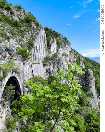 Dramatic Limestone Rock Pillars And Historic Stone Arch On Napoleonica Trail - Trieste Karst Climbing Bouldering Area, Adriatic Sea View, Italy Outdoor Adventure Hiking Dramatic Limestone Rock Pillars And Historic Stone Arch On Napoleonica Trail - Trieste Karst Climbing Bouldering Area, Adriatic Sea View, Italy Outdoor Adventure Hiking 141638662