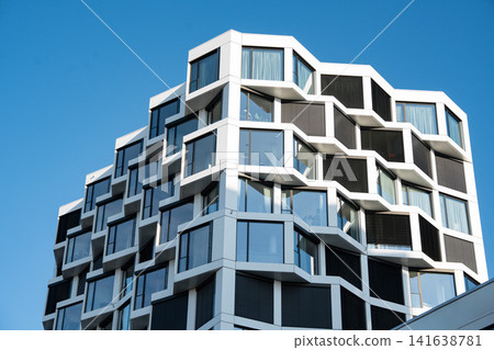 Modern Residential High-Rise Building In Munich With Contemporary Architecture, Blue Windows And Clear Sky - Urban Development Real Estate Photography Modern Residential High-Rise Building In Munich With Contemporary Architecture, Blue Windows And Clear Sky - Urban Development Real Estate Photography 141638781