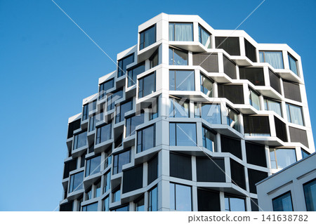 Modern Residential High-Rise Building In Munich With Contemporary Architecture, Blue Windows And Clear Sky - Urban Development Real Estate Photography Modern Residential High-Rise Building In Munich With Contemporary Architecture, Blue Windows And Clear Sky - Urban Development Real Estate Photography 141638782