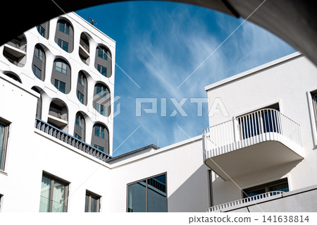 Modern Munich Residential Complex - Upward Perspective - Contemporary White Architecture Against Blue Sky Modern Munich Residential Complex - Upward Perspective - Contemporary White Architecture Against Blue Sky 141638814