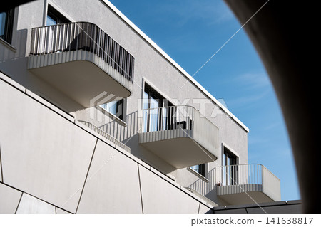 Modern Munich Residential Complex - Upward Perspective - Contemporary White Architecture Against Blue Sky Modern Munich Residential Complex - Upward Perspective - Contemporary White Architecture Against Blue Sky 141638817