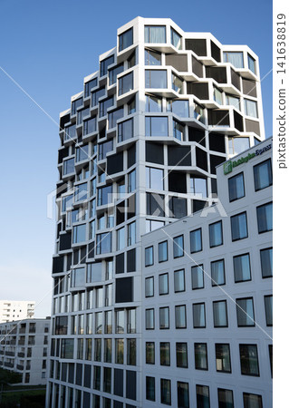 Modern Residential High-Rise Building In Munich With Contemporary Architecture, Blue Windows And Clear Sky - Urban Development Real Estate Photography Modern Residential High-Rise Building In Munich With Contemporary Architecture, Blue Windows And Clear Sky - Urban Development Real Estate Photography 141638819