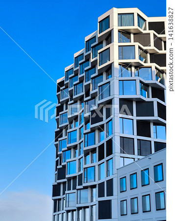 Modern Residential High-Rise Building In Munich With Contemporary Architecture, Blue Windows And Clear Sky - Urban Development Real Estate Photography Modern Residential High-Rise Building In Munich With Contemporary Architecture, Blue Windows And Clear Sky - Urban Development Real Estate Photography 141638827