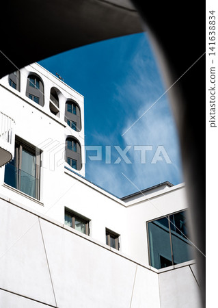 Modern Munich Residential Complex - Upward Perspective - Contemporary White Architecture Against Blue Sky Modern Munich Residential Complex - Upward Perspective - Contemporary White Architecture Against Blue Sky 141638834