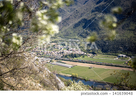 Adige River Valley And Dolci Village Viewed From Placca Del Forte San Marco: Panoramic Spring Landscape Near Lake Garda Adige River Valley And Dolci Village Viewed From Placca Del Forte San Marco: Panoramic Spring Landscape Near Lake Garda 141639048