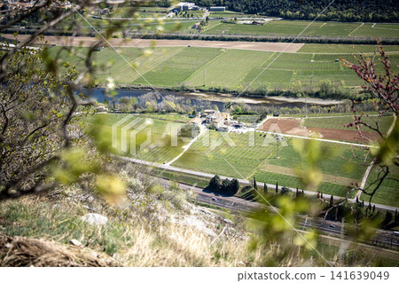 Adige River Valley And Dolci Village Viewed From Placca Del Forte San Marco: Panoramic Spring Landscape Near Lake Garda Adige River Valley And Dolci Village Viewed From Placca Del Forte San Marco: Panoramic Spring Landscape Near Lake Garda 141639049