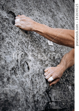 Climber Using Side Pocket Grip With Taped Fingers On Rock Surface: Close Up Of Precision Hand Placement Outdoors Climber Using Side Pocket Grip With Taped Fingers On Rock Surface: Close Up Of Precision Hand Placement Outdoors 141639125