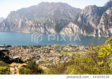 Panoramic View Over Riva Del Garda From Belvedere Climbing Garden: Scenic Landscape In Province Of Trento At Lake Garda Italy Panoramic View Over Riva Del Garda From Belvedere Climbing Garden: Scenic Landscape In Province Of Trento At Lake Garda Italy 141639130