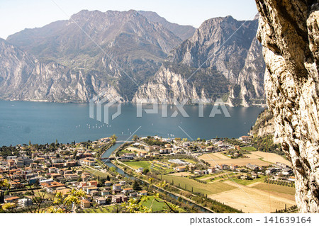 Panoramic View Over Riva Del Garda From Belvedere Climbing Garden: Scenic Landscape In Province Of Trento At Lake Garda Italy Panoramic View Over Riva Del Garda From Belvedere Climbing Garden: Scenic Landscape In Province Of Trento At Lake Garda Italy 141639164