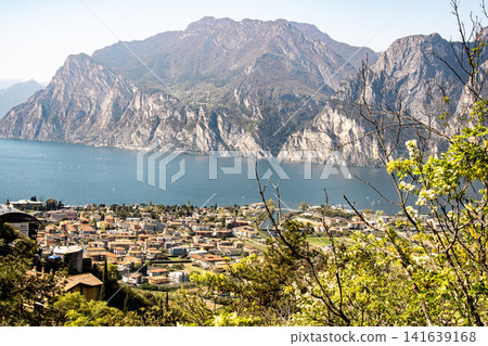 Panoramic View Over Riva Del Garda From Belvedere Climbing Garden: Scenic Landscape In Province Of Trento At Lake Garda Italy Panoramic View Over Riva Del Garda From Belvedere Climbing Garden: Scenic Landscape In Province Of Trento At Lake Garda Italy 141639168