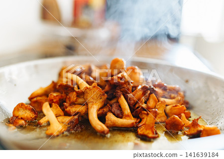 Fried chanterelle mushrooms in a frying pan Fried chanterelle mushrooms in a frying pan 141639184