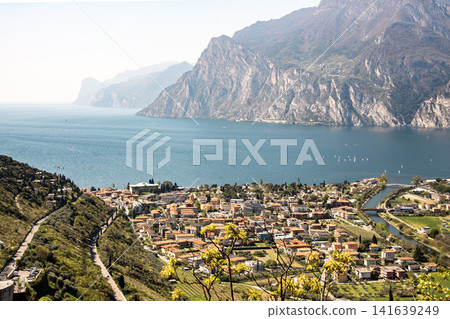Panoramic View Over Riva Del Garda From Belvedere Climbing Garden: Scenic Landscape In Province Of Trento At Lake Garda Italy Panoramic View Over Riva Del Garda From Belvedere Climbing Garden: Scenic Landscape In Province Of Trento At Lake Garda Italy 141639249