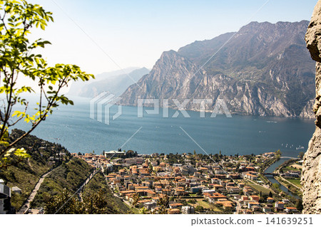 Panoramic View Over Riva Del Garda From Belvedere Climbing Garden: Scenic Landscape In Province Of Trento At Lake Garda Italy Panoramic View Over Riva Del Garda From Belvedere Climbing Garden: Scenic Landscape In Province Of Trento At Lake Garda Italy 141639251